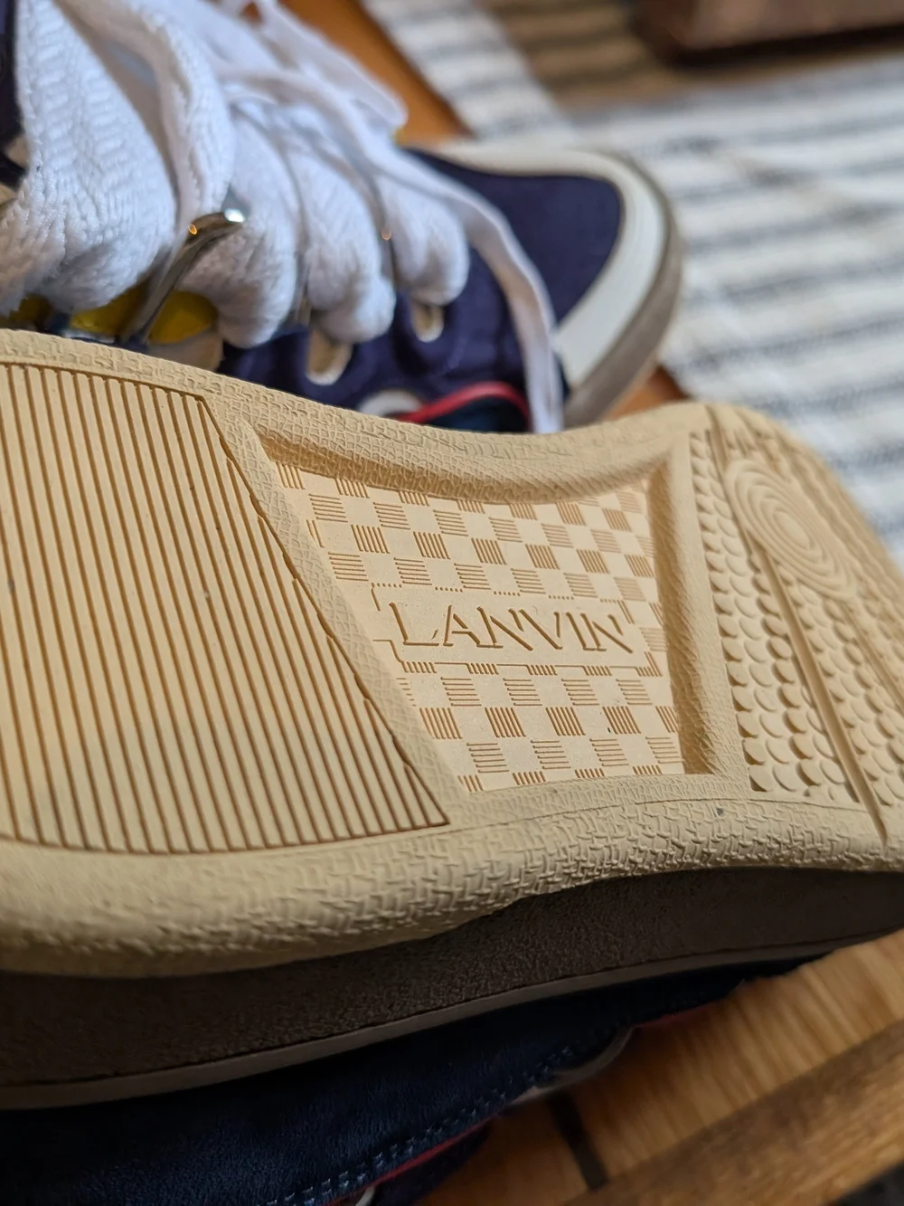 Lanvin Curb Sneakers in a distinct Navy Blue, White, Red, and Yellow colorway.